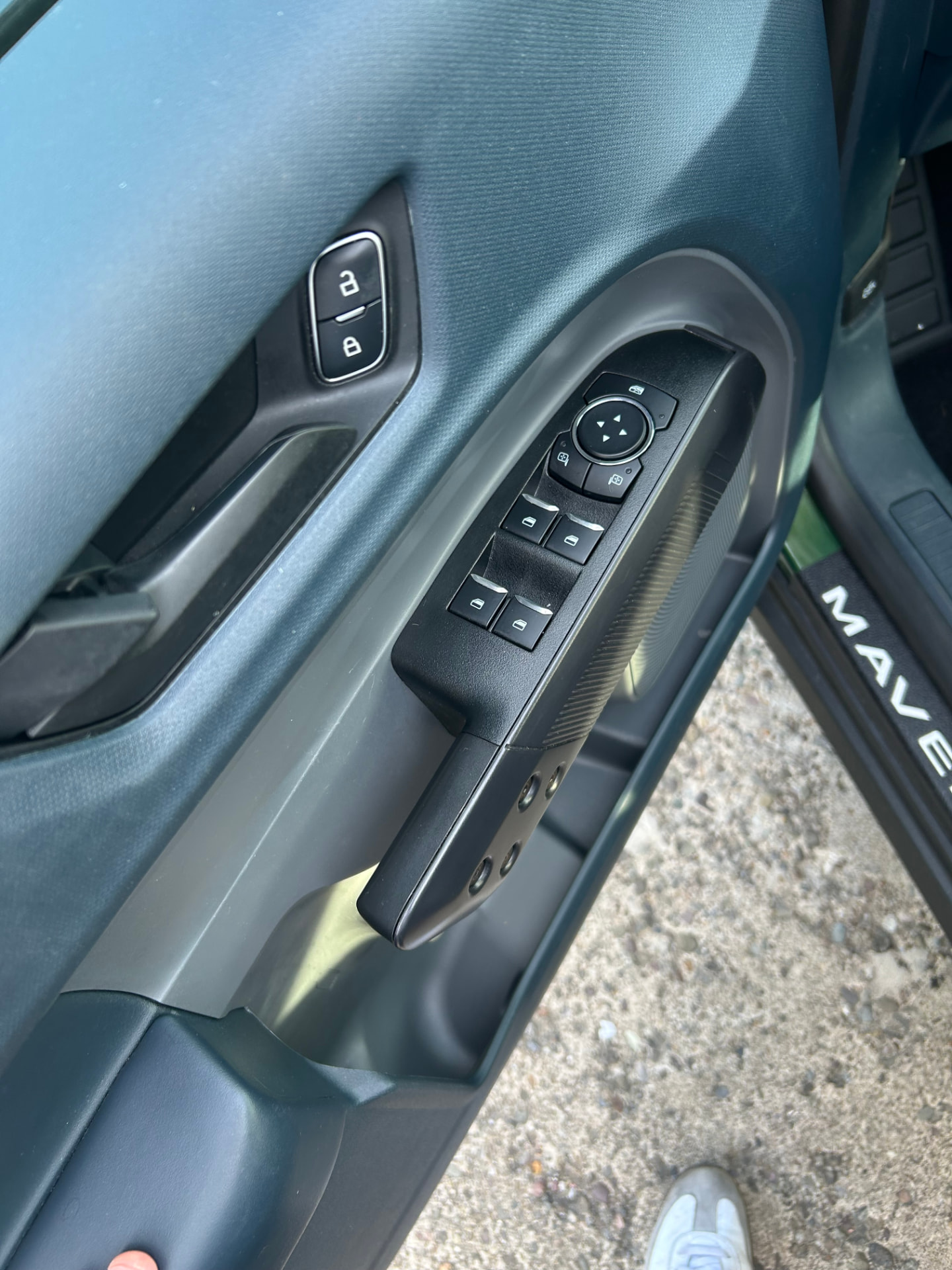 Ford Maverick driver door panel with window controls
