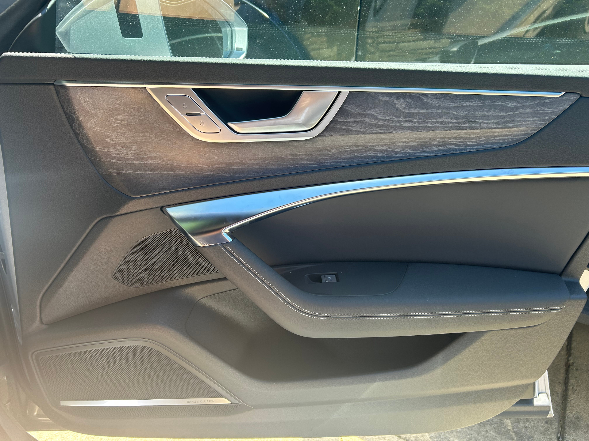 Audi black interior door with chrome and wood trim